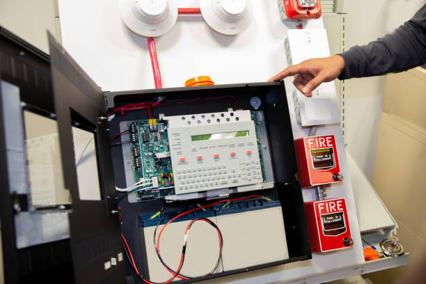 Pull station fire alarm system attached to a white wall used for training of security guards.